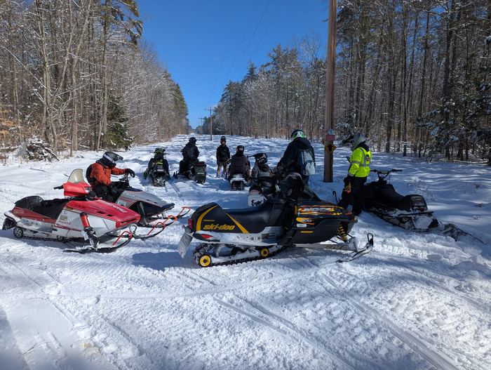 Group of riders stopped along the trail corridor